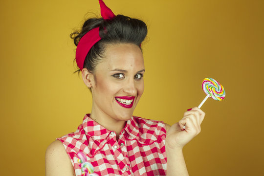 Close up portrait beautiful pin up girl with colorful lollipops
