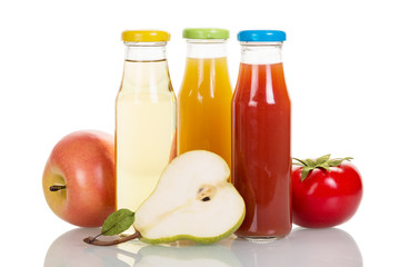 Bottles of fruit and vegetable juices isolated on white.