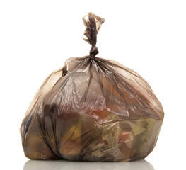Garbage bags with food waste isolated on white.