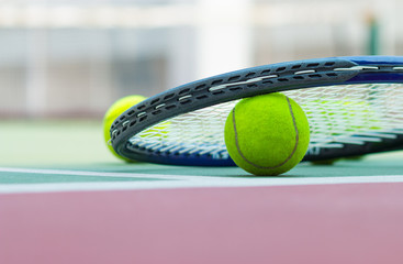 Tennis Ball with Racket on the clay tennis court