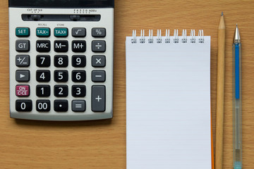 Calculator, notebook, pencil and pen