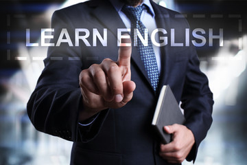 Fototapeta na wymiar Businessman is pressing on the virtual screen and selecting Learn English.