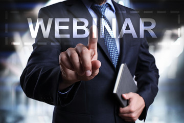 Businessman is pressing on the virtual screen and selecting Webinar