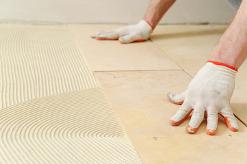 Laying plywood on the floor.