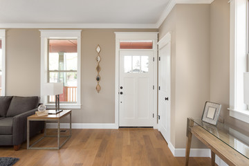Foyer and entryway in new home with hardwood floors, couch, lamp