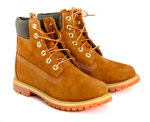 Brown lady's boots with shoelace on white background.