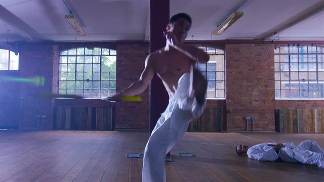  Outnumbered martial arts fighter skilfully uses nunchaku 