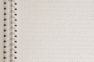 Close up of paper page with braille text.