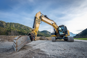 Fototapeta na wymiar huge heavy shovel excavator digger on gravel construction site
