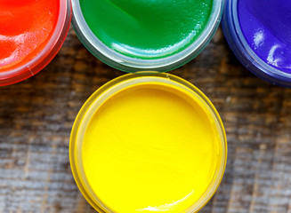 cans gouache on a wooden background