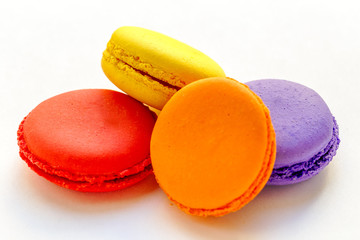 colorful and tasty french macaroons on white background