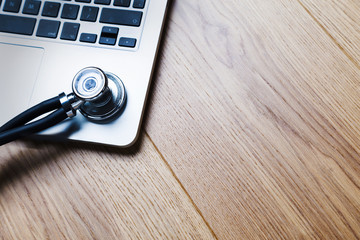 Laptop and stethoscope closeup