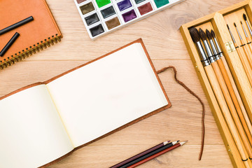 Fototapeta premium Desktop with notepad and paint