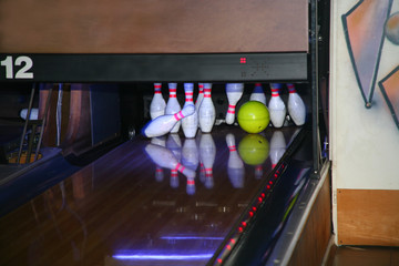 A bowling ball slams into the pins