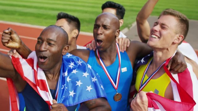  Group of athletes (disabled & able bodied) celebrate victory on running track