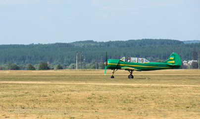 green airplane with propeller on airfield at Kharkiv airshow