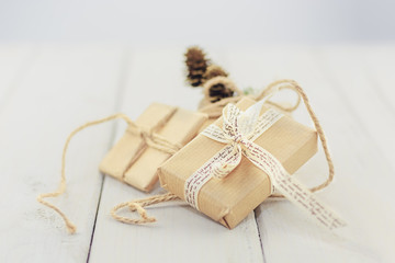 Three boxes tied with a rope, ribbon and decorate with a sprig o