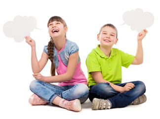 two funny children sitting on the floor with paper clouds in hands laughing isolated on white...