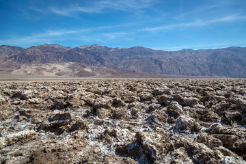 Beautiful scenario, sand formations in the foreground, blue sky day at the Death Valley National Park, Arizona, USA