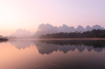 Sunrise at Li River, Xingping, Guilin, China. Xingping is a town in North Guangxi, China. It is 27 kilometers upstream from Yangshuo on the Li River - obrazy, fototapety, plakaty
