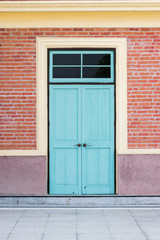 Blue door in the red wall.