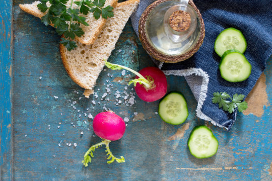 Fresh vegetables and bread on a wooden vintage background. The p