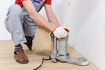 Worker polishing  parquet.