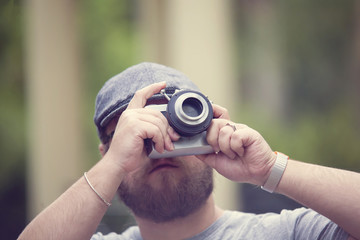 Young stylish photographer with vintage camera