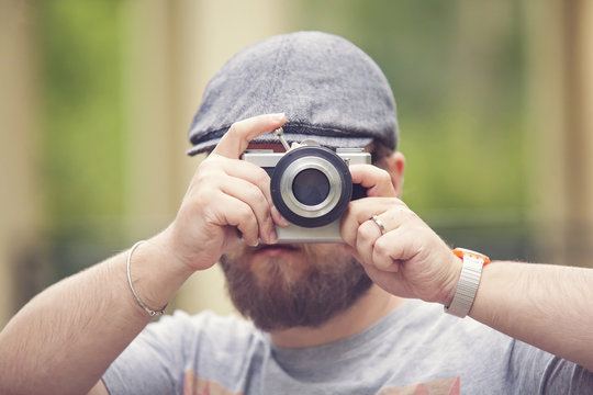 Young stylish photographer with vintage camera