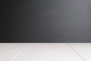 White wooden plank surface and black slate stone wall as blank template 