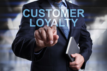Fototapeta na wymiar Businessman is pressing on virtual screen and selecting Customer loyalty.