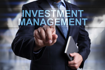 Businessman is pressing on virtual screen and selecting Investment management.