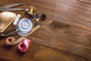 Sewing kit on the wooden background
