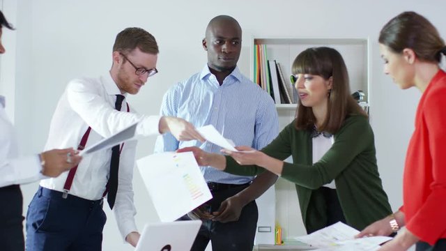 Business group in office meeting one worker is watching their colleagues