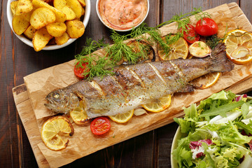 Baked fish with roasted potatoes and salad