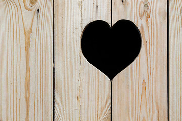 Light beige wooden background with a heart. Vintage texture. Wooden background.