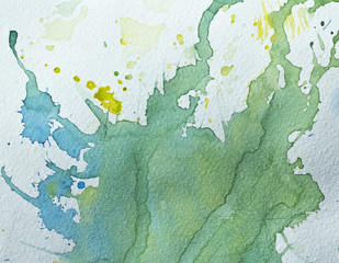 Abstract painted watercolor background on paper texture. Stains paint. Green, blue, yellow painted spots.