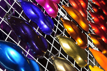 Car metallic paint samples, stand with examples of glowing colors coating for different vehicles, bronze, brown, orange, purple, beige, blue, azure, red variations of transport bodywork surface  © antonmatveev