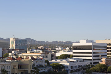 House on a background of mountain range. City, mountain and blue sky in USA, Santa Monica. 