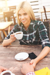 Cheerful young man and woman in cafeteria