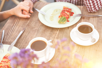 Cheerful loving couple is resting in cafeteria