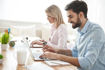 Fototapeta premium Cheerful creative team is using modern technology