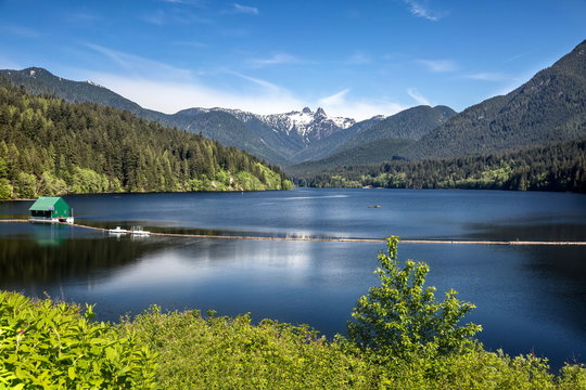 Capilano Reservoir Lake Long Reflection Green Building Dam Snowy  Snow Mountains Vancouver British Columbia Pacific Northwest