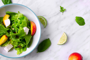 spinach salad with fruit on marble on a top