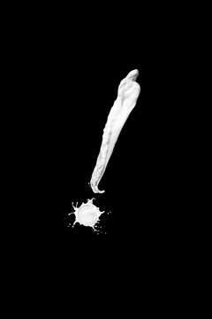 exclamation mark made of milk, isolated on black