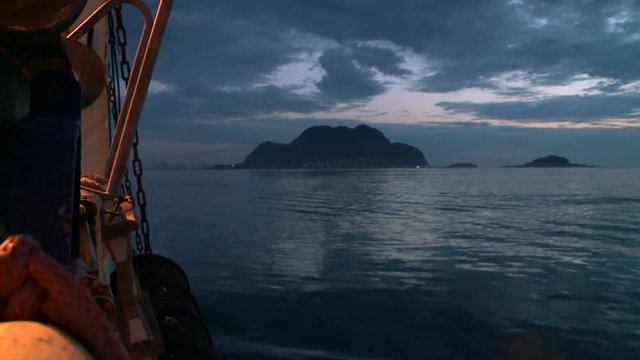 Evening view of the shore with floating vessel