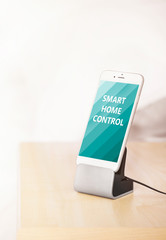 Smart home control concept. Smart phone near bed