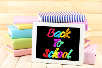 Back to school message on screen of tablet-pc
