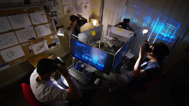  Group of young male computer gamers immersed in a virtual reality game