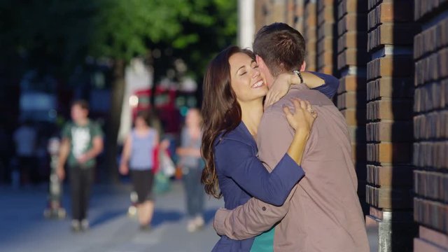  Attractive romantic couple embrace outdoors in the city